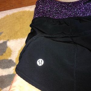 Black LuLuLemon shorts with purple waistband